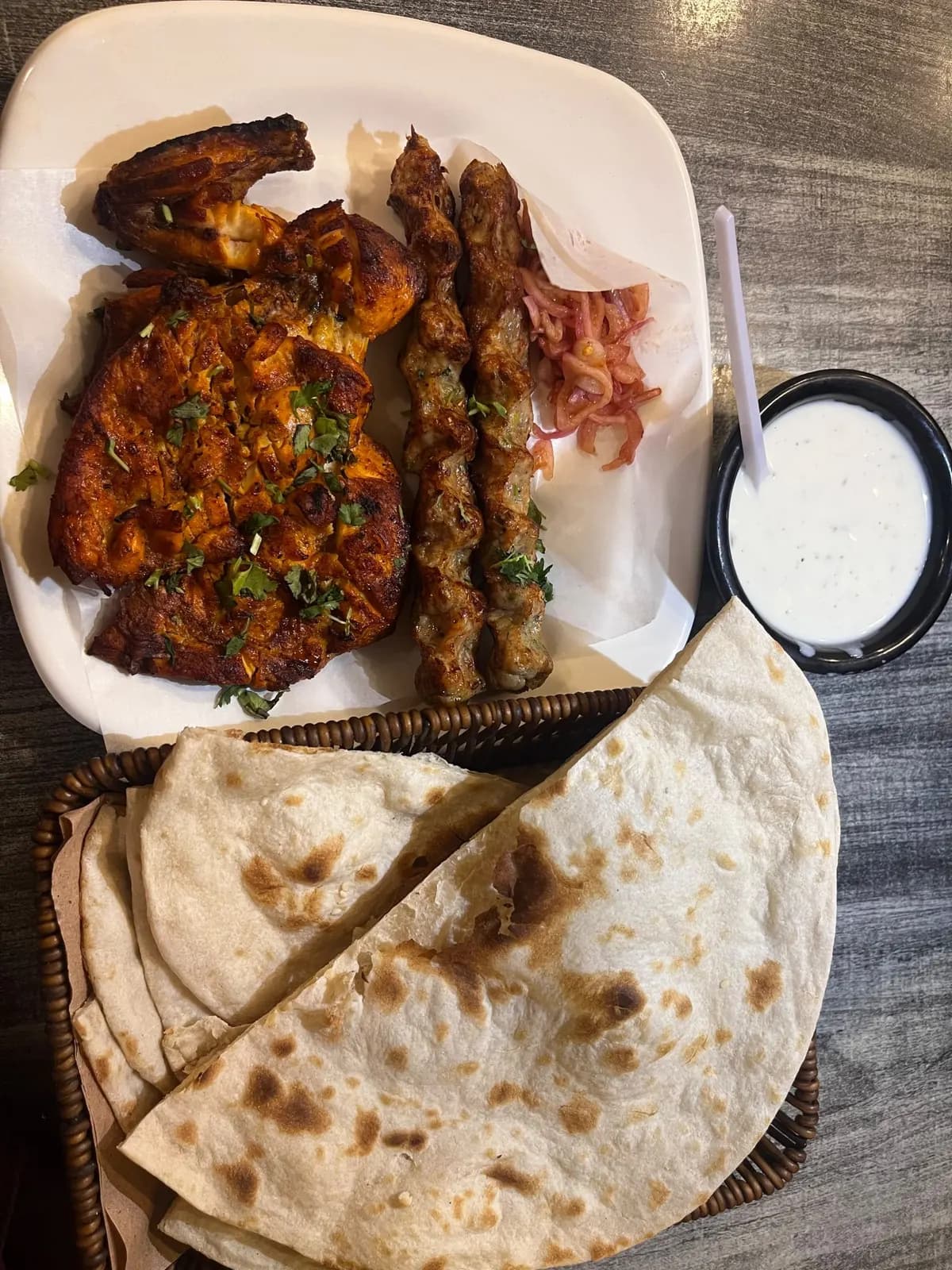 Grilled chicken kebab with flatbread and sauce