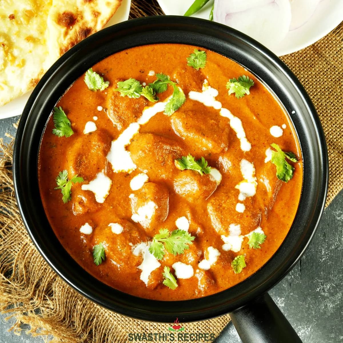 A curry served with rice and naan bread