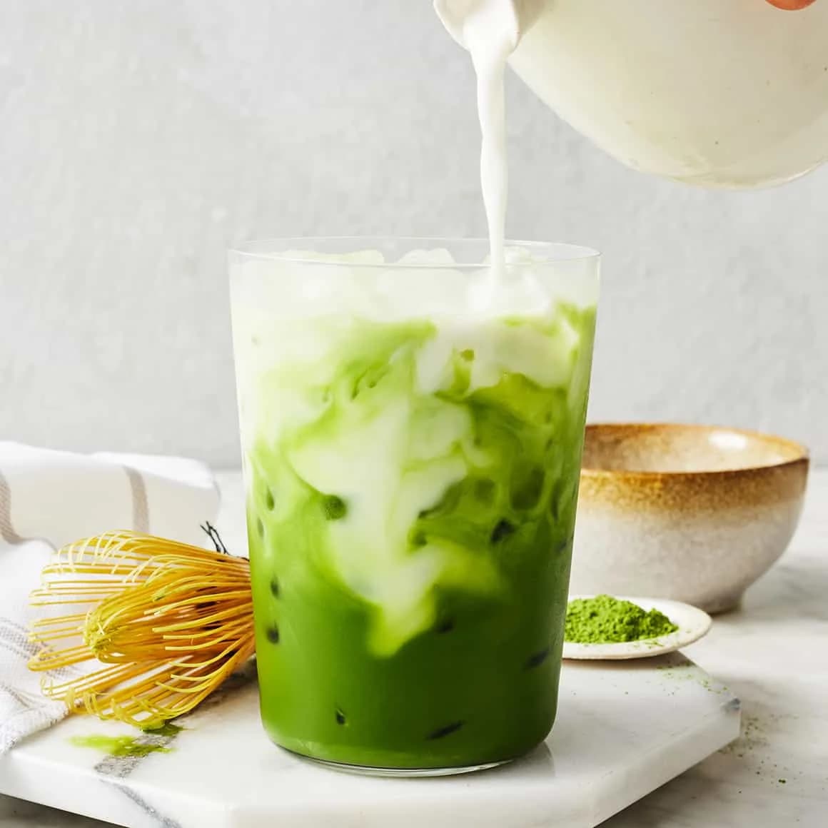 A takeaway cup of iced drink with a straw