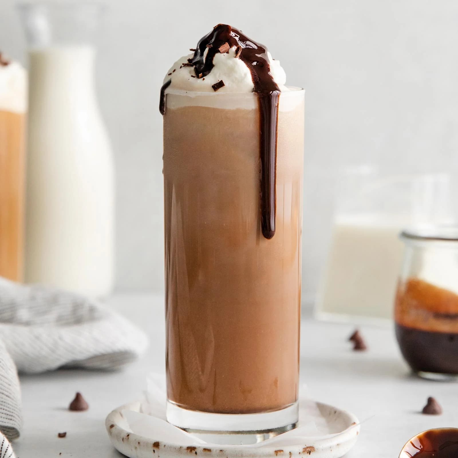 A takeaway cup of iced drink with a straw